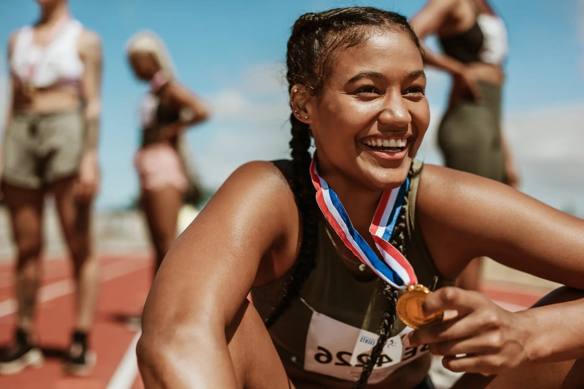 Woman smiling after winning race with nootropics for reaction time
